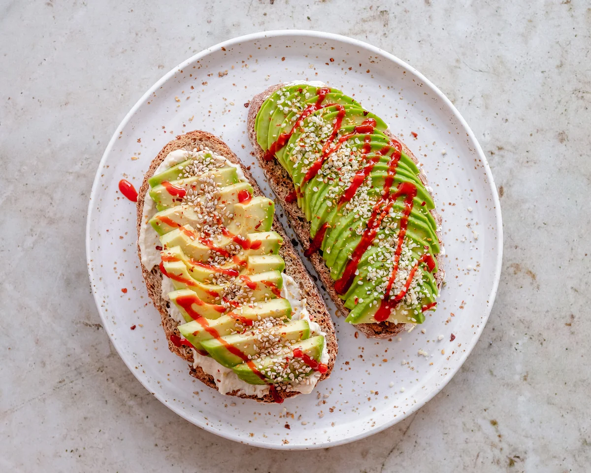 Avocado toast sprinkled with everything bagel seasoning and sriracha