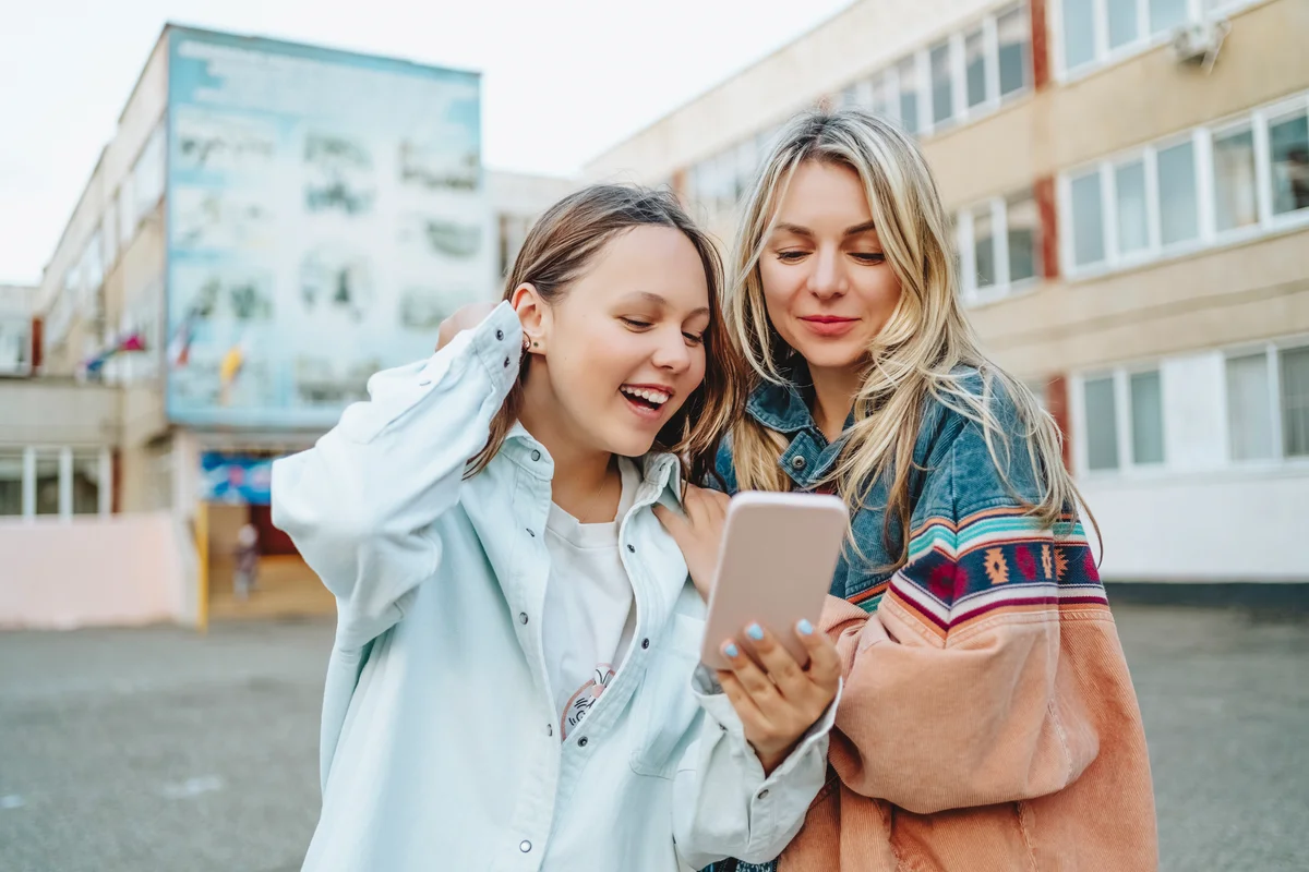 Mom & teen daughter looking at phone