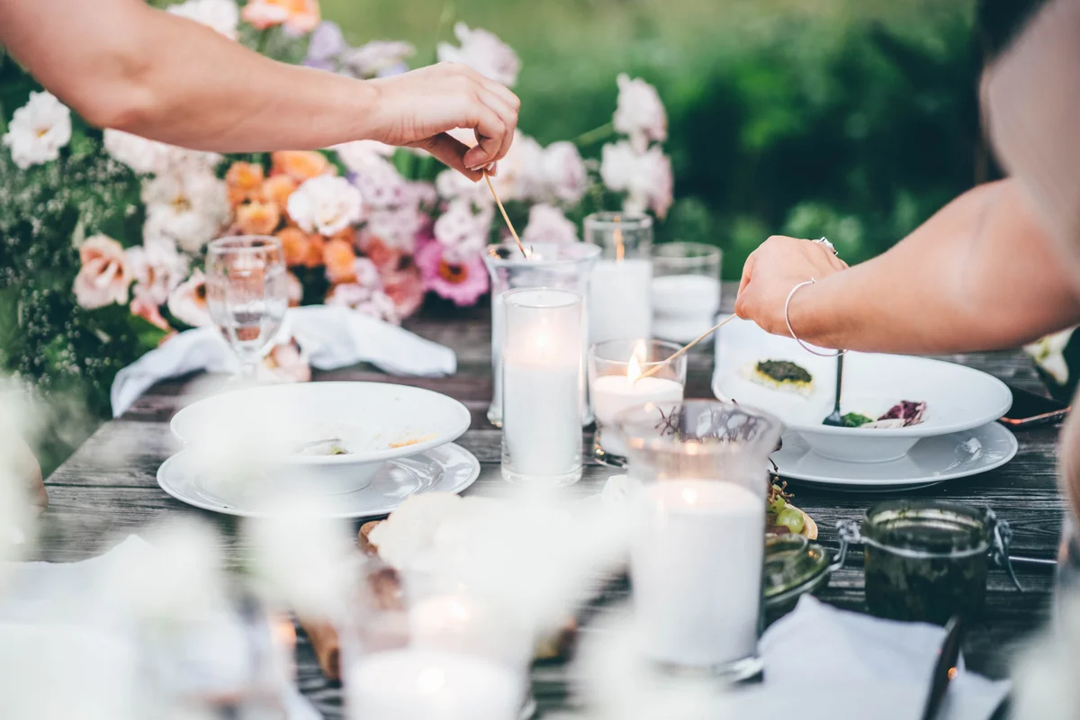 Lighting candles on outdoor table setting