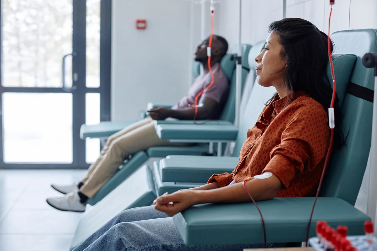 Man and woman donating blood in hospital
