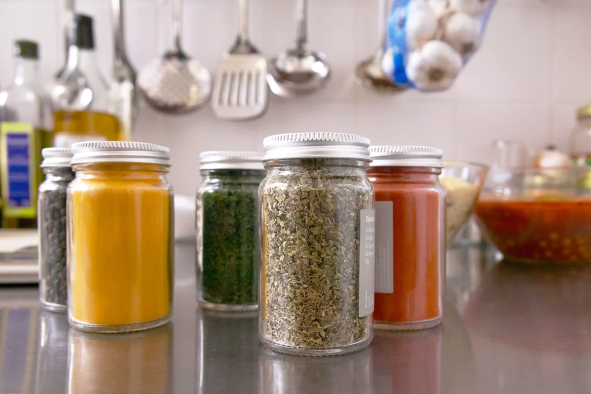 Jars filled with herbs and spices in kitchen