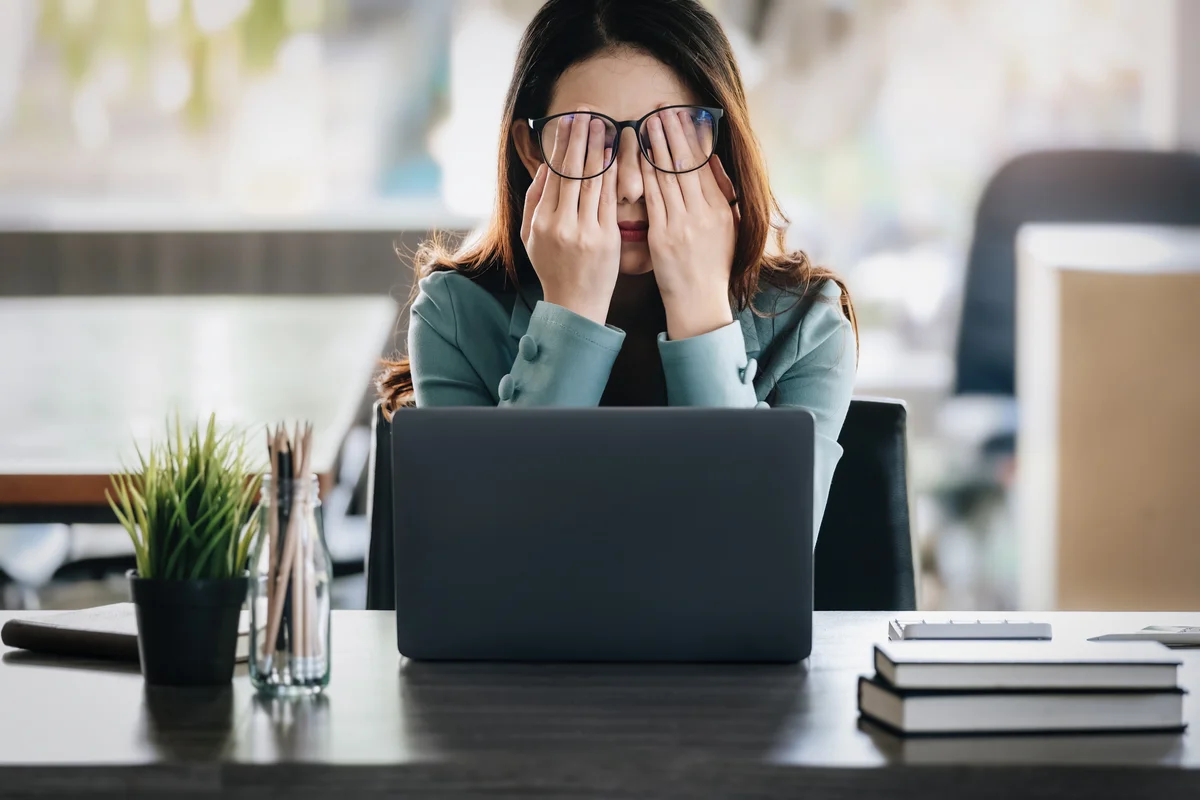 Frustrated woman sitting at desk