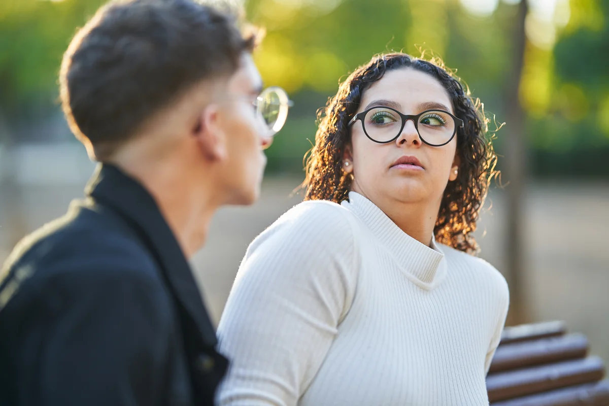 Shocked woman talking to man