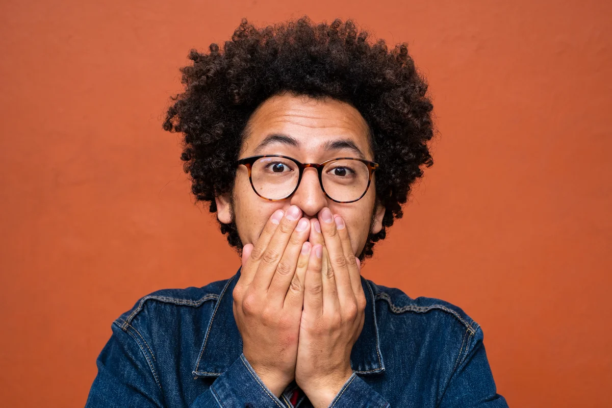 Man covering mouth
