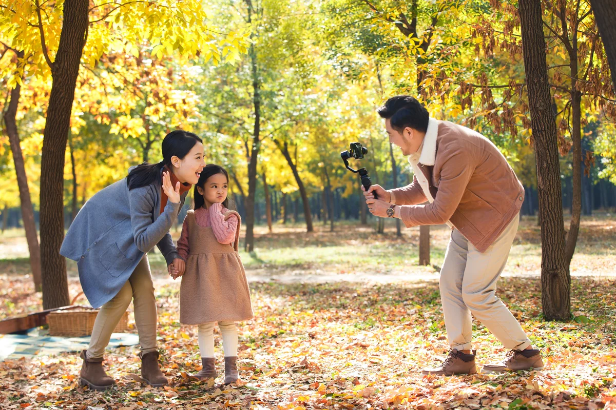 Happy family in the outdoor taking pictures