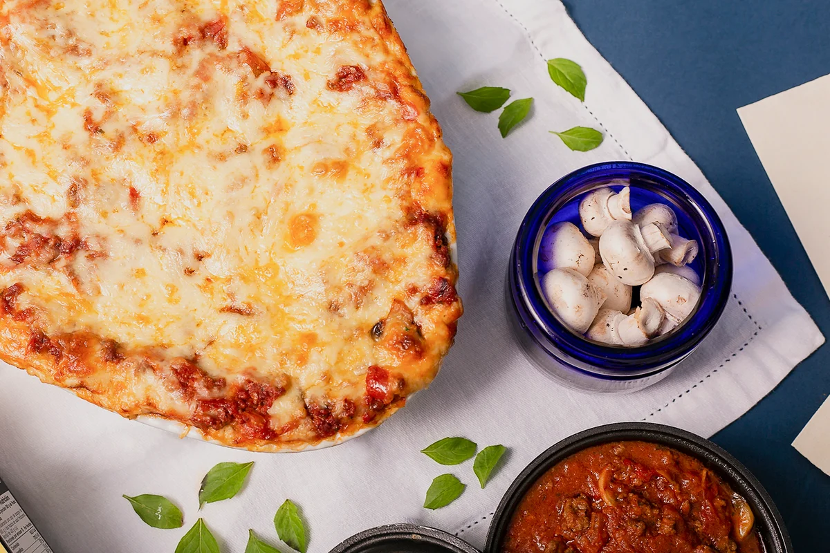 High angle view of pizza with ingredients on table