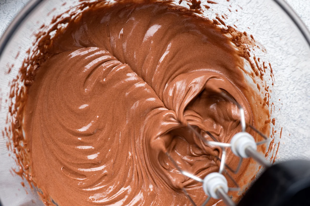 Mixing chocolate cake batter with electric mixer