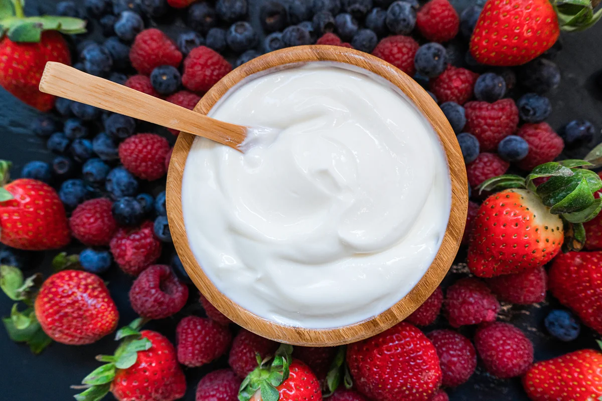 Greek yogurt in a glass jars with spoons