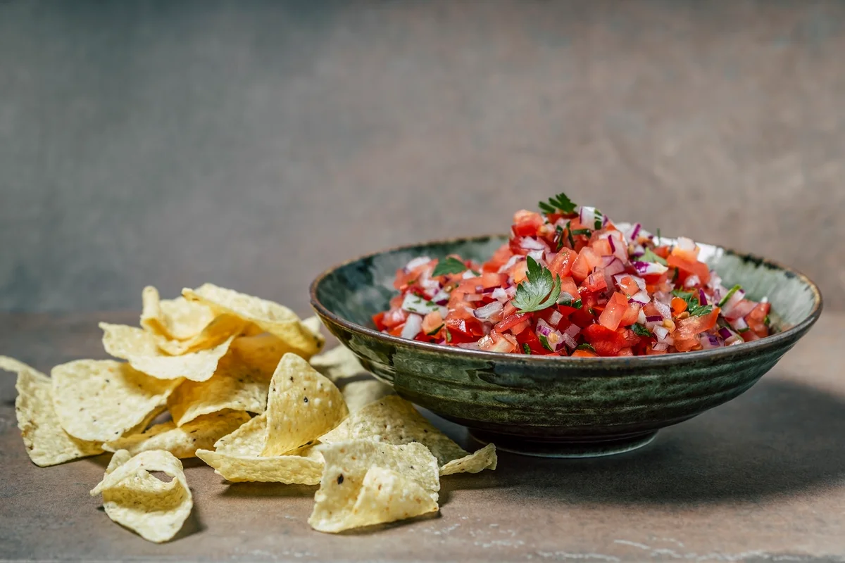 A bowl of salsa and chips