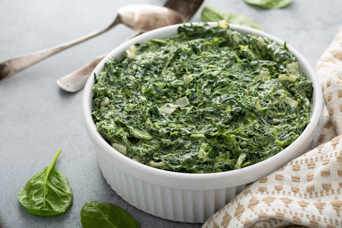 Creamed spinach in a white bowl