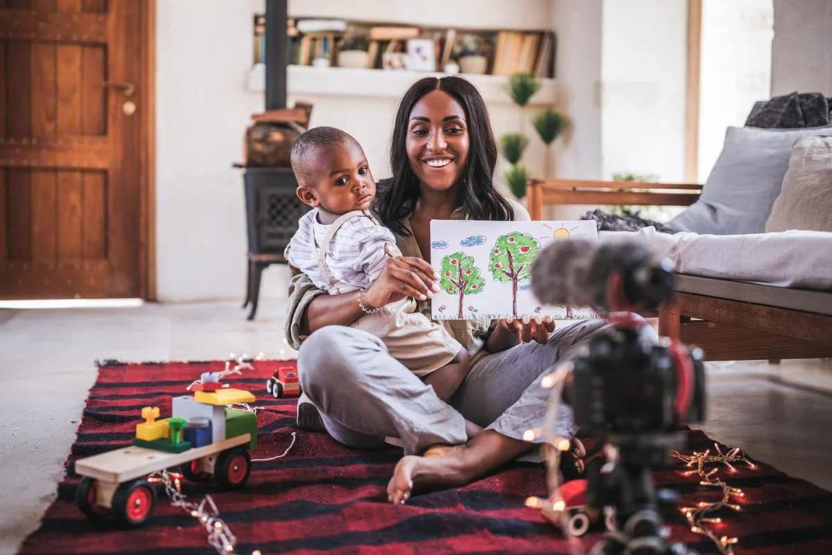 Vlogger mother with little son recording video
