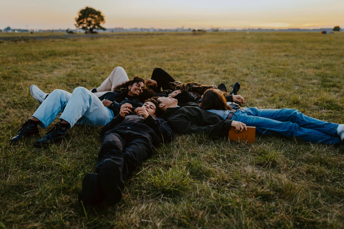 Group of friends laying in the grass