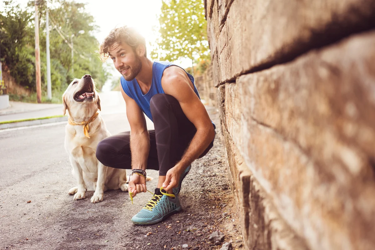 Young man jogging with his dog
