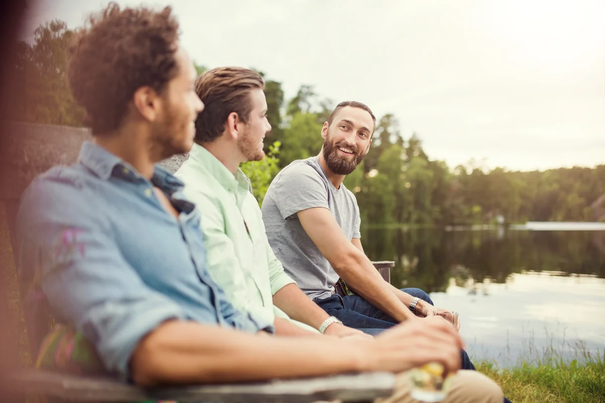 3 guys hanging out by the water