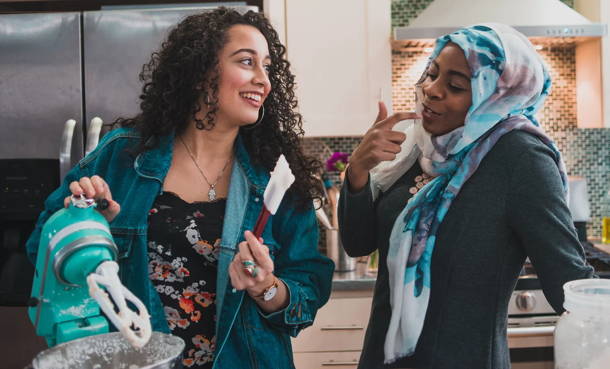 Two friends baking in kitchen