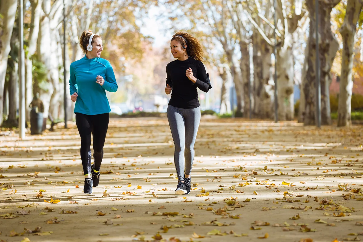 two women running in park