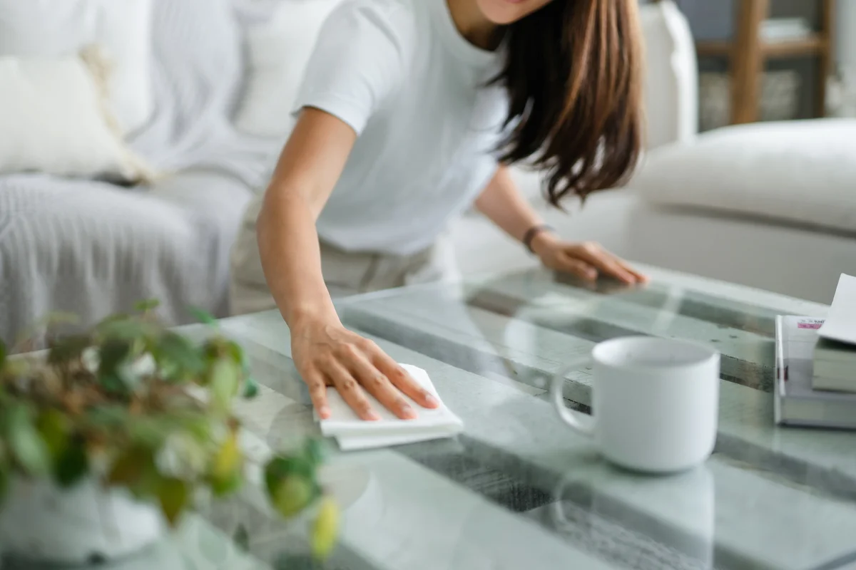 Woman dusting her table