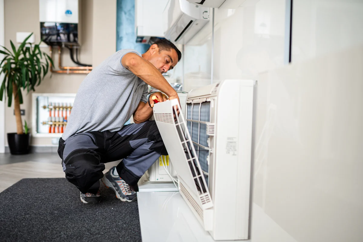 Man cleaning air conditioner