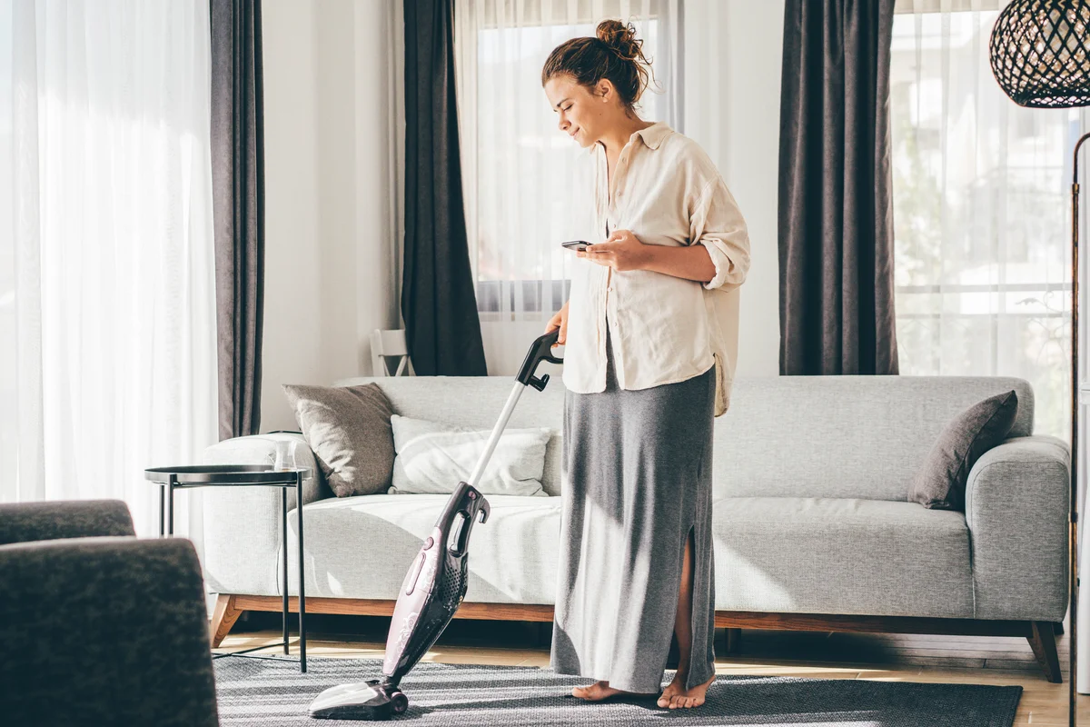 Woman vacuuming house