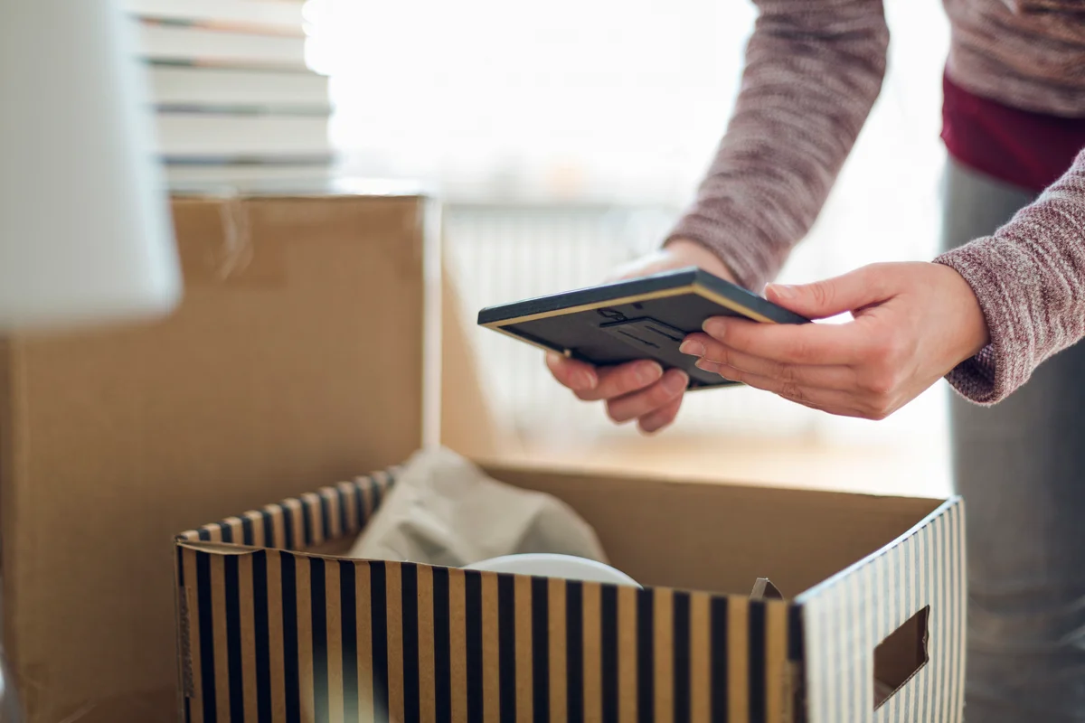 Woman looking at photo from box