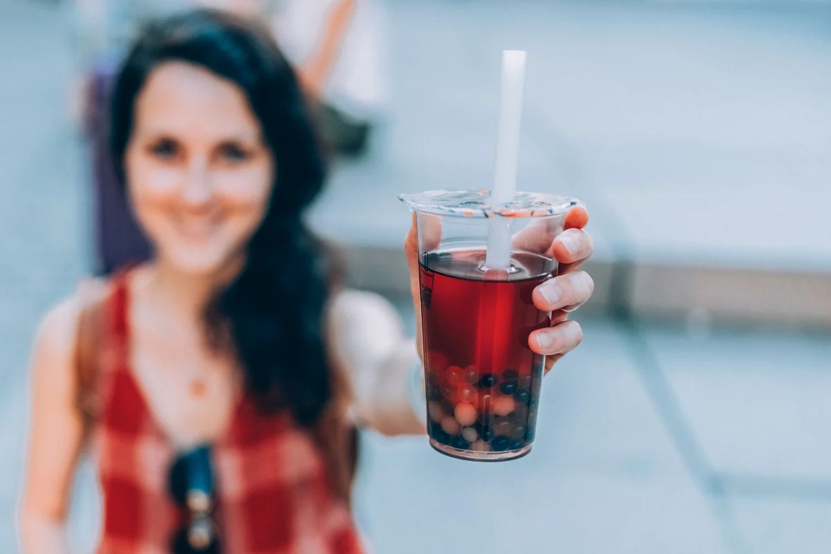 Woman showing her Boba Berry Breeze drink