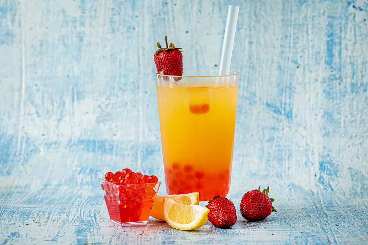 Lemonade with bubble tea on blue stone background