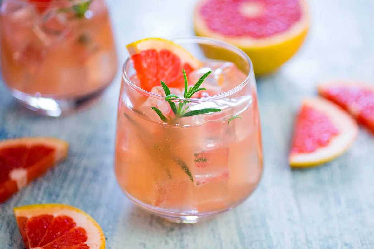 Glass of fresh grapefruit juice and grapefruits