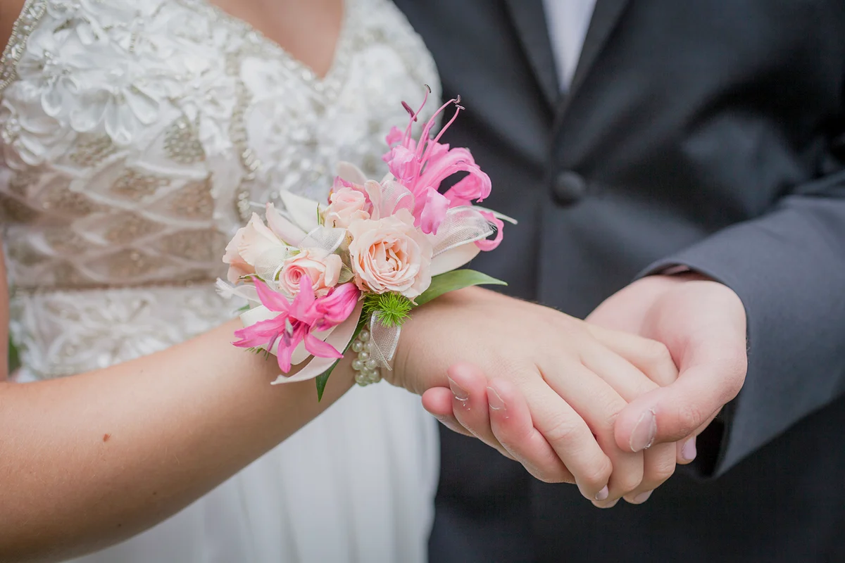 teenage couple holding hands in prom attire