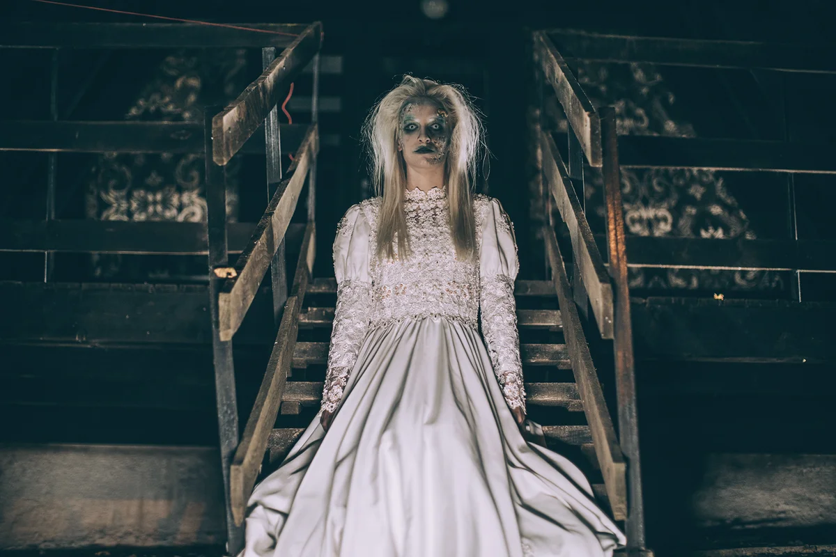 Scary witch standing on steps