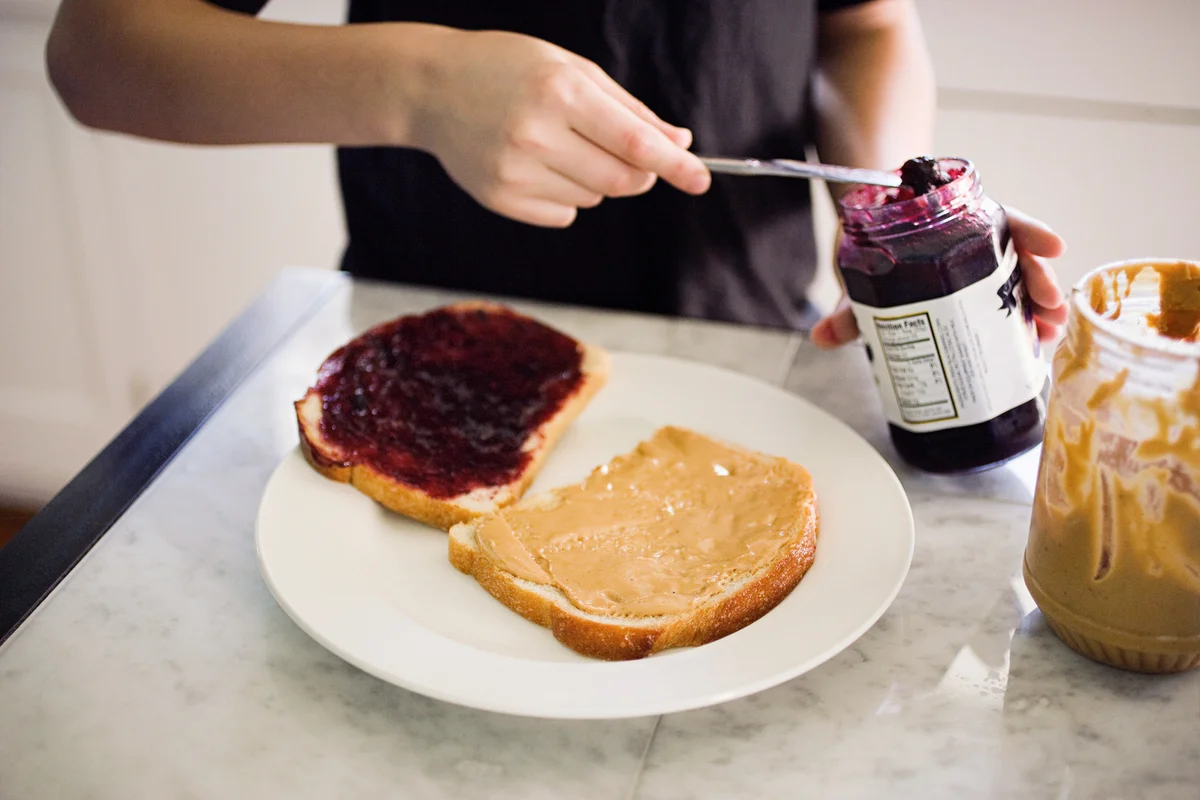 Boy making peanut butter sandwich