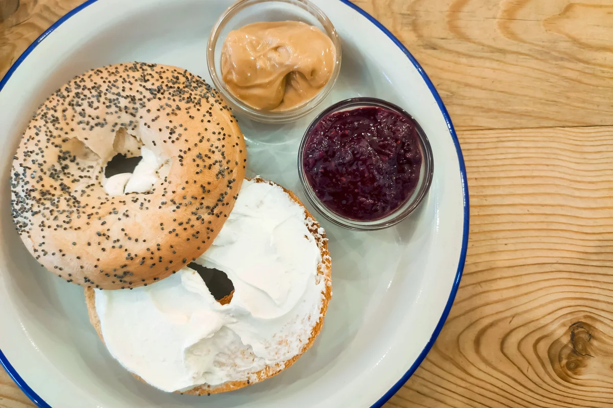 Bagel with cream cheese, peanut butter and blackberry jam
