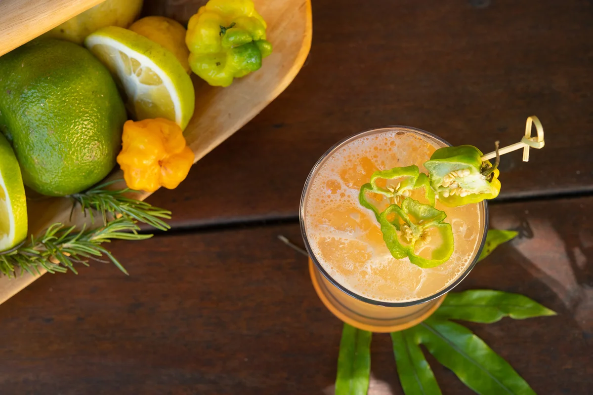 Cocktail with garnish photographed on wooden surface
