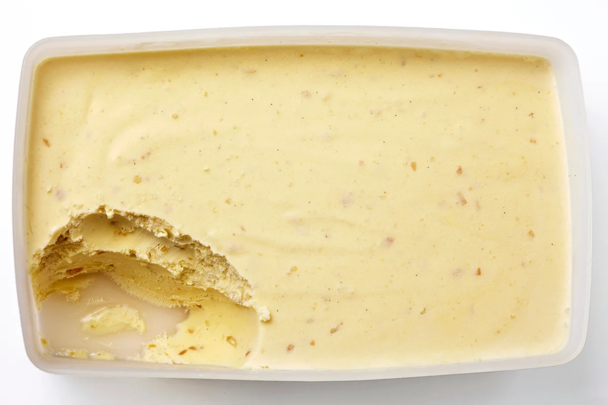 Tub of banana ice cream with scoop taken out