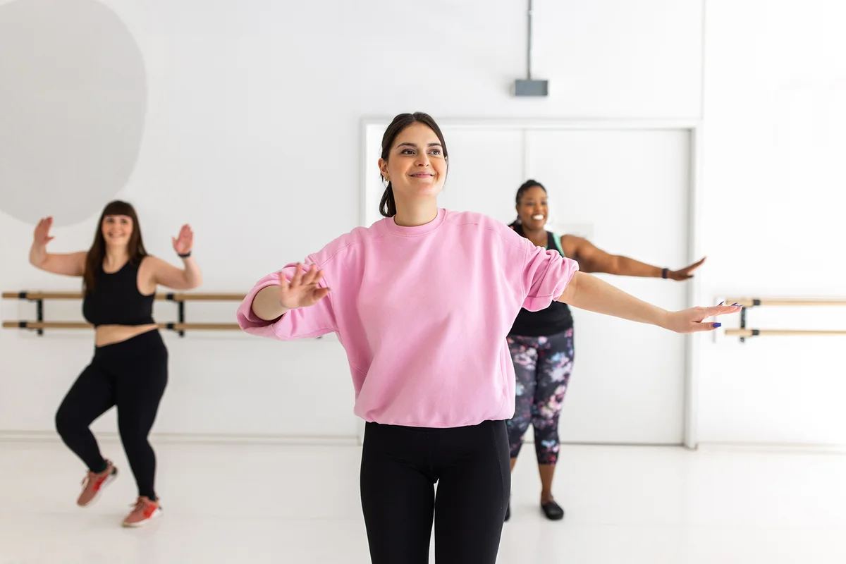 Woman doing zumba dance at fitness class