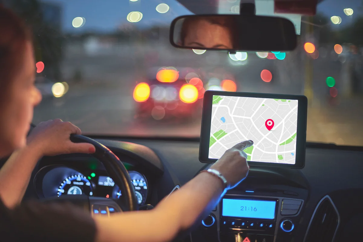 Woman Sitting In Car And Using Navigation System