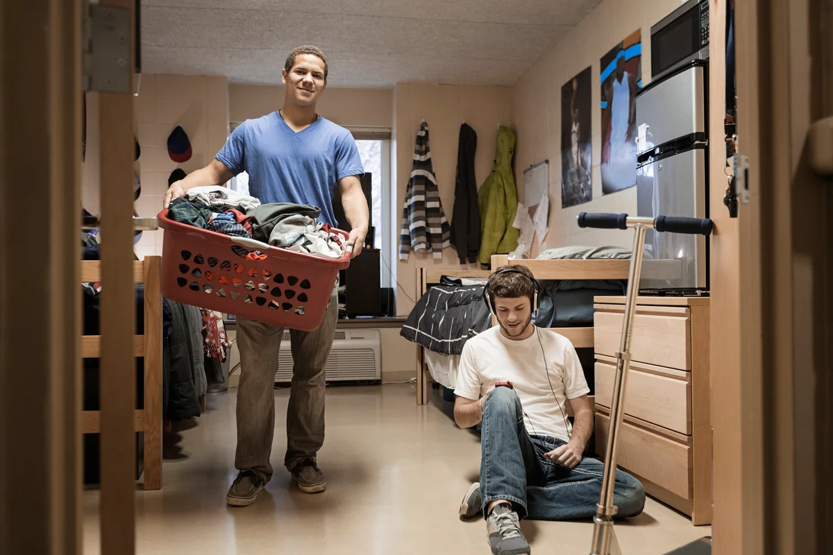 students with laundry baskets