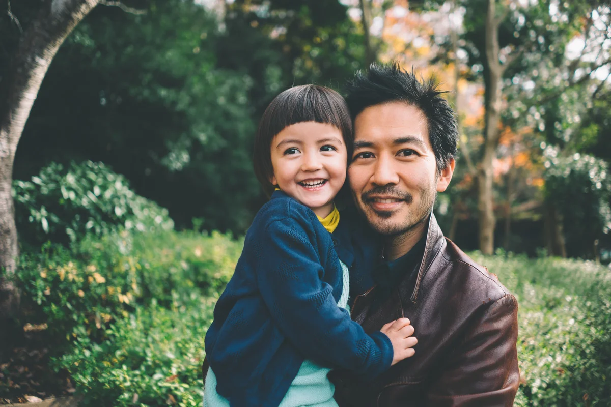 Father and child smiling at camera