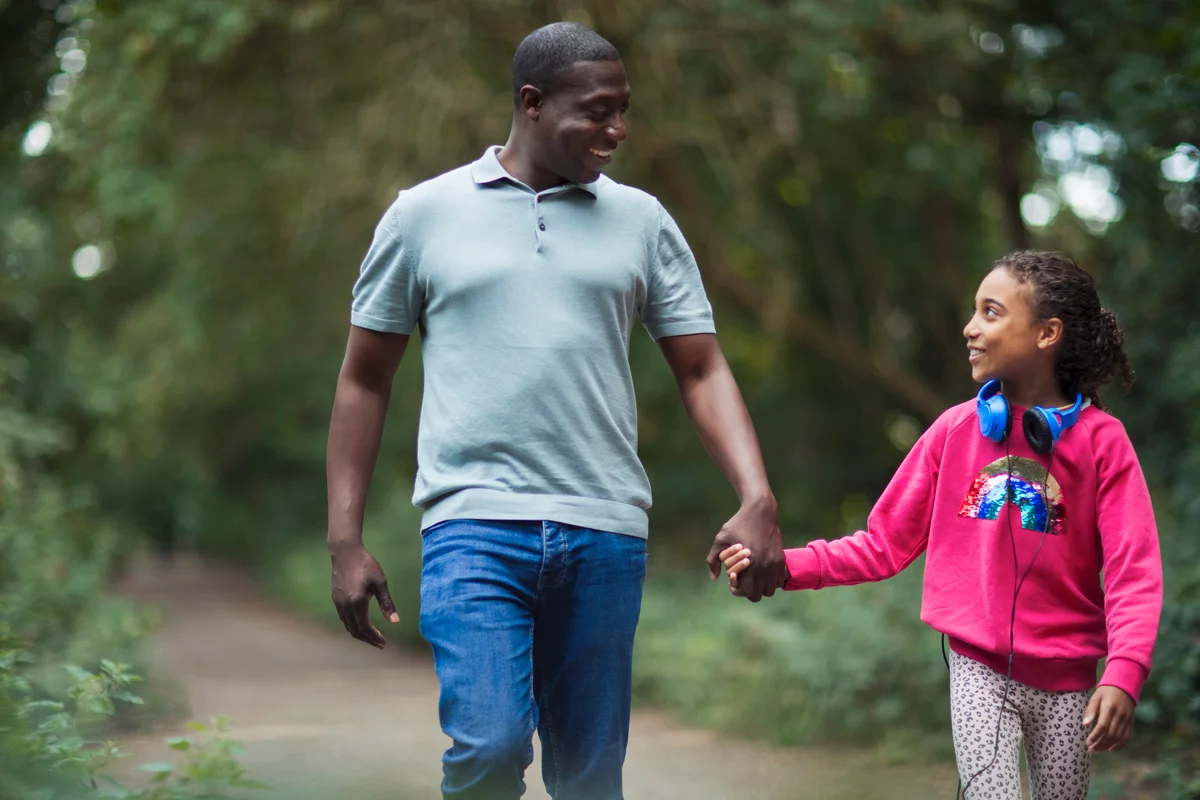 Father and daughter walking and holding hands