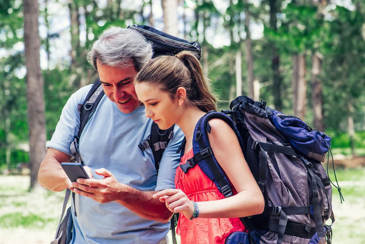Dad and teen daughter backpacking