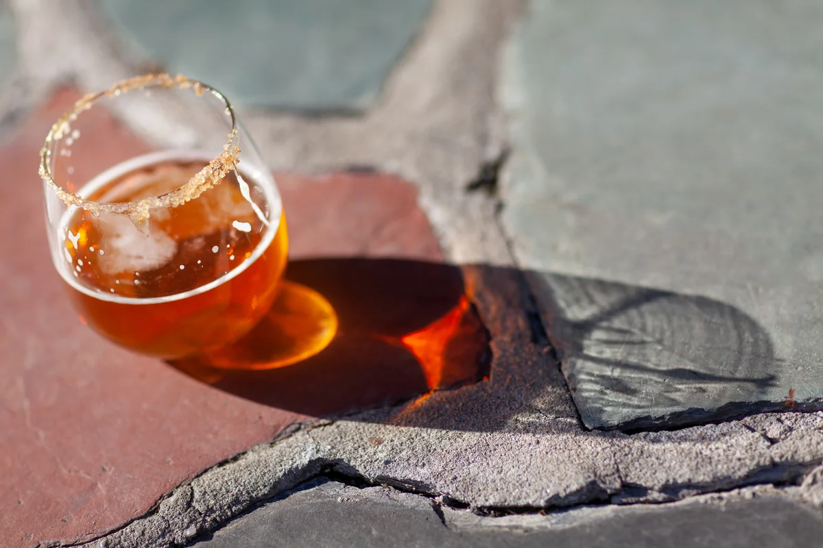 Cocktail with cinnamon on rim of glass