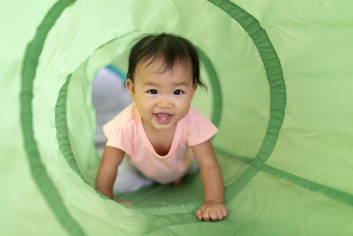 Baby crawling through tube