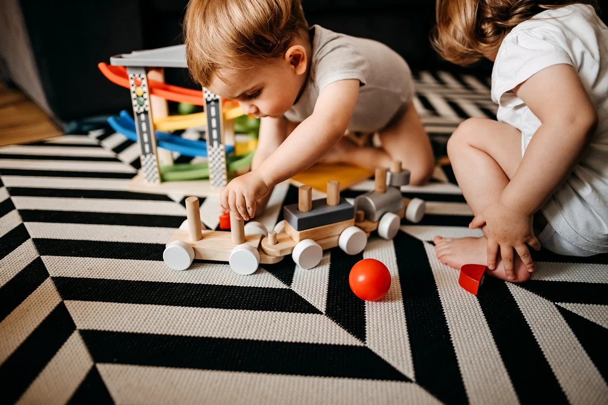 Two babies playing with toys
