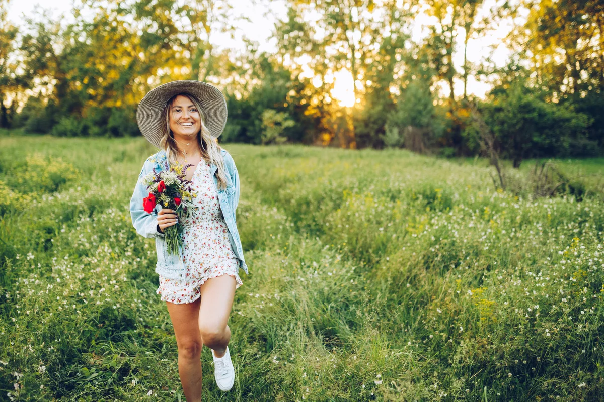 Woman wearing florals and picking wildflowers