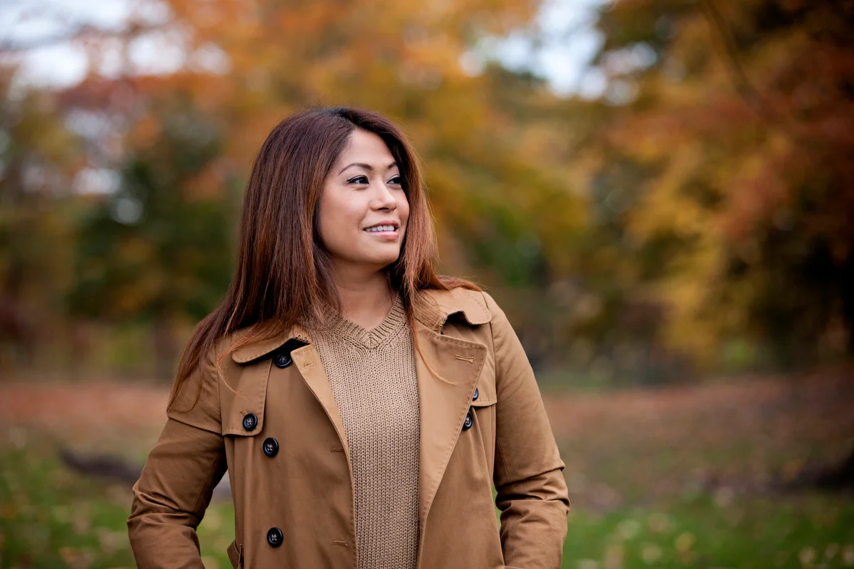 Woman outside in the fall wearing warm neutral colors
