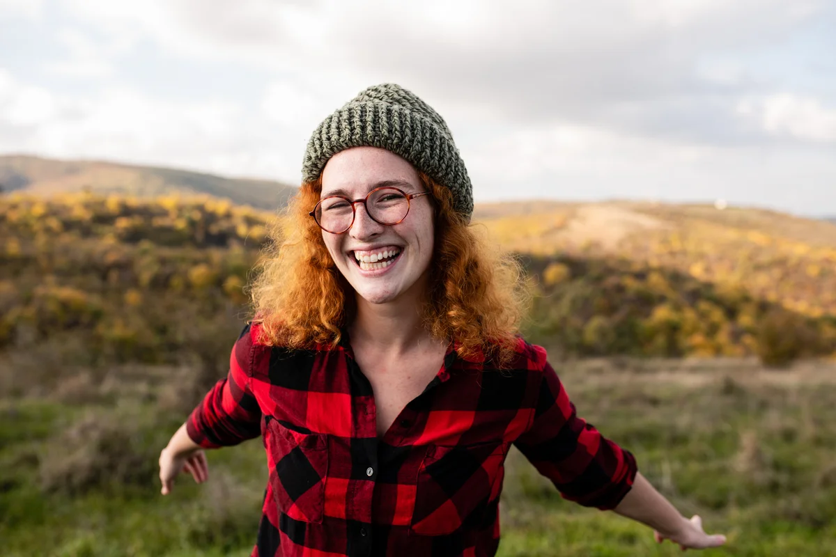 Red headed woman wearing red flannel and beanie