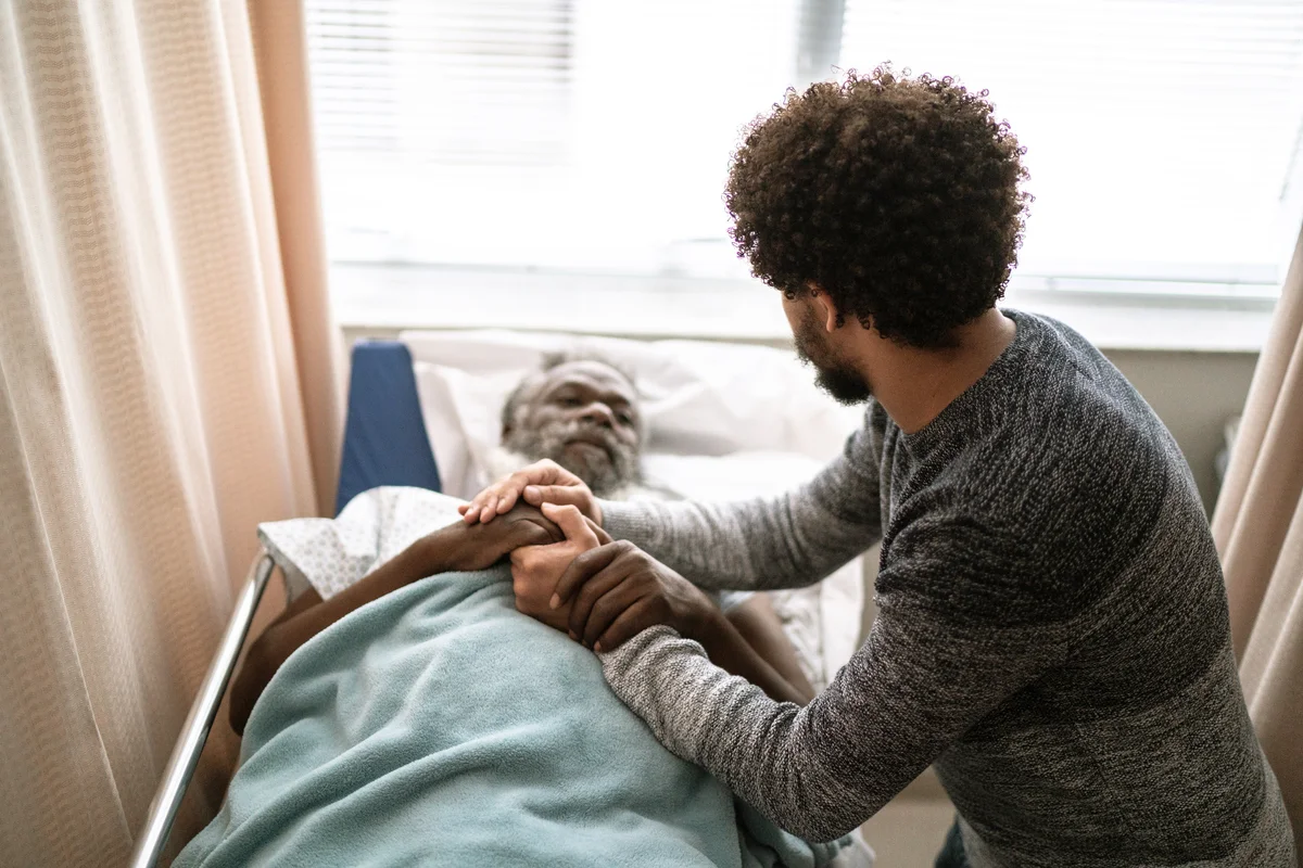 Young man visiting hospitalized father