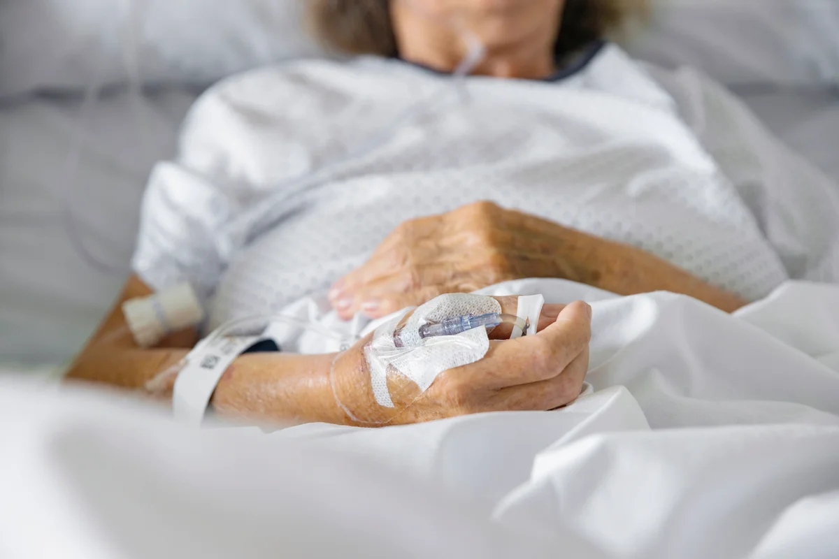 Elderly female patient in hospital bed