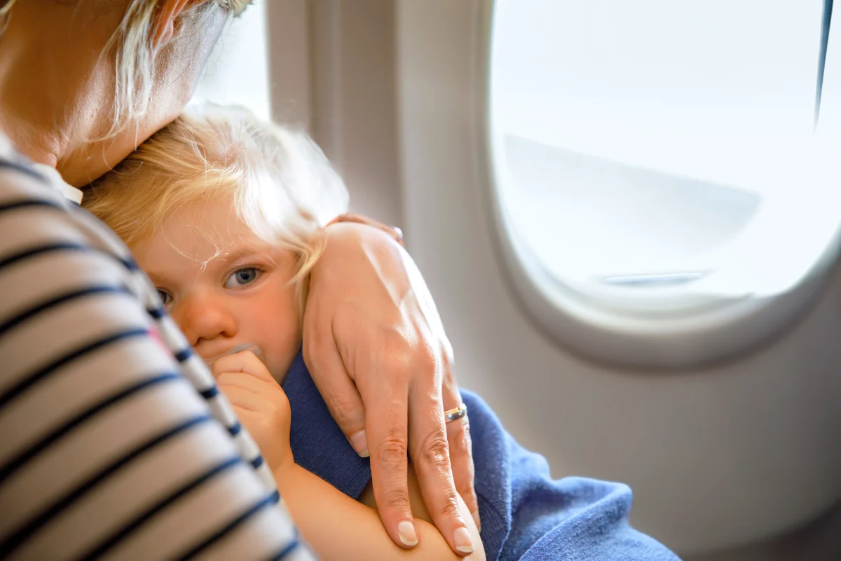 Woman traveling with little child by airplane