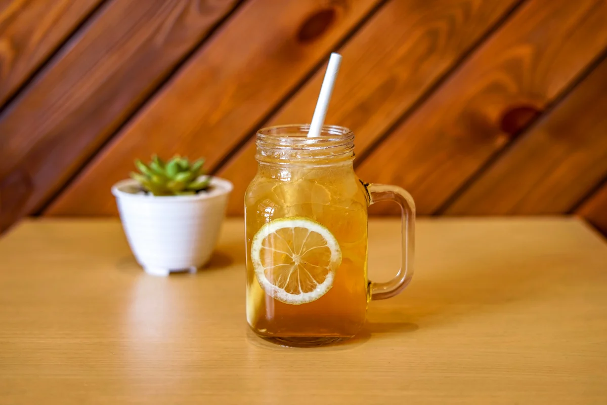 Whiskey cinnamon cocktail in jar on table