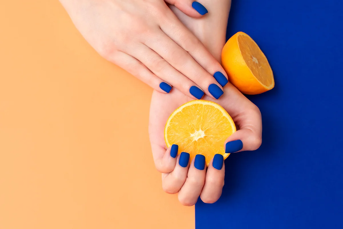 manicured nails colored with blue and orange nail polish